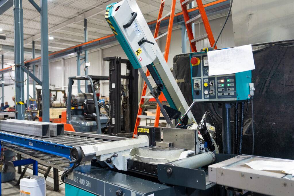 "Precision metal cutting equipment in action at ATH Custom Metal Fabrication workshop."